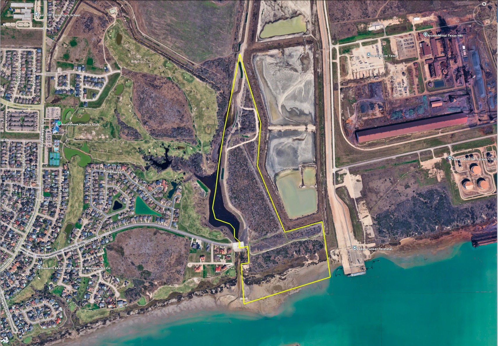 Owner-supplied aerial showing approximate tract boundary in yellow, lake, bay, nearby residences and industrial facilities