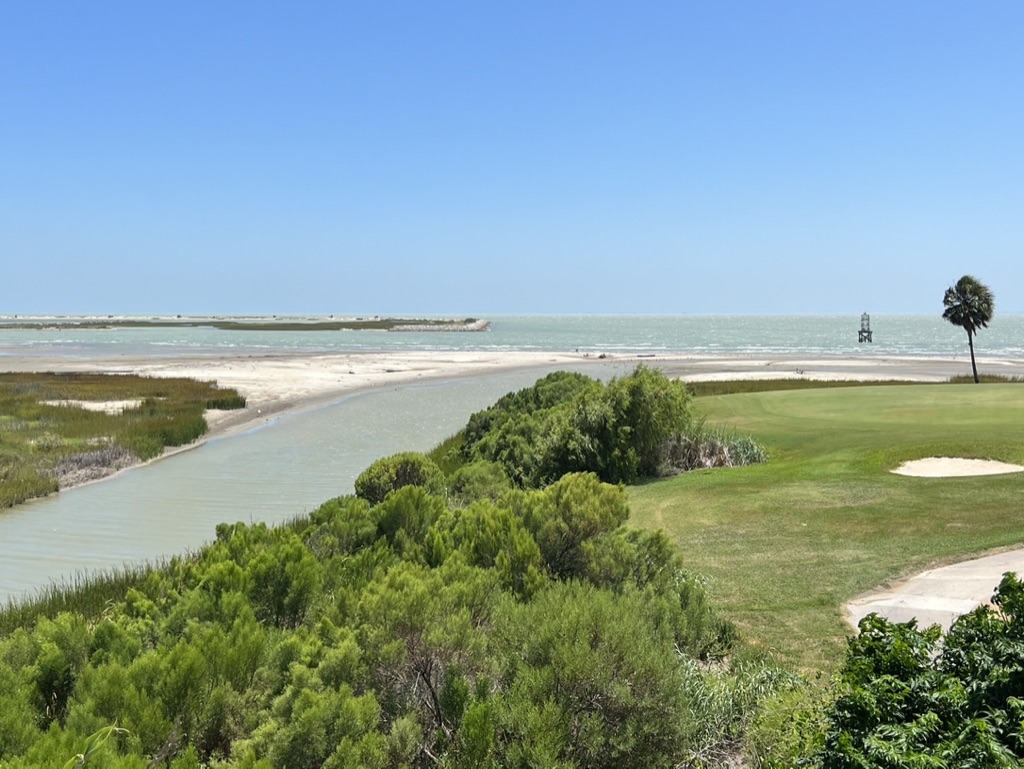 Owner-supplied surrounding-area golf-course and coastal photograph